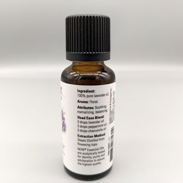 Side of the NOW lavender bottle: ingredient, aroma, attributes, Head Ease Blend and extraction method