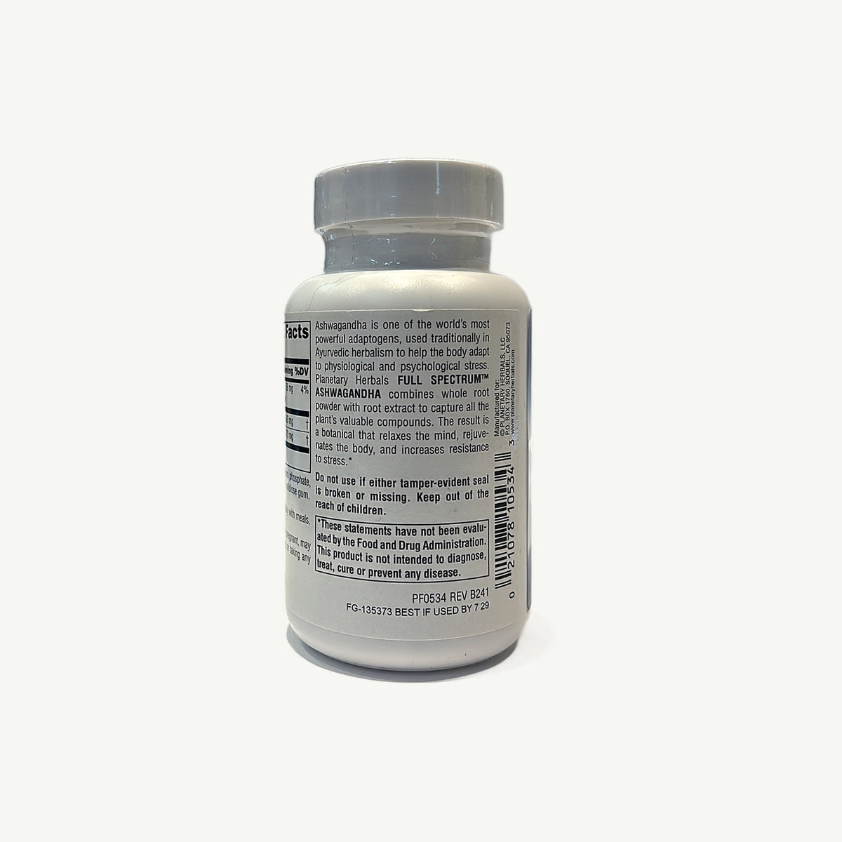 Frasco de Full Spectrum Ashwagandha, foto real de la tienda: lado con descripción, sello, niños, aviso de la FDA y fecha