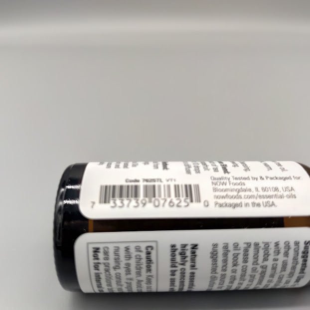 Bottom of the NOW tea tree bottle: barcode and packaged for NOW Foods, Bloomingdale, IL