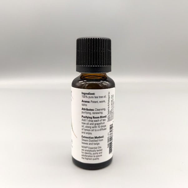 Side of the NOW tea tree bottle: ingredient, aroma, attributes, room blend and extraction method